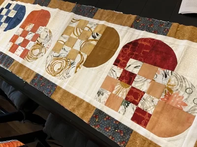 Photo of fall colored Swedish Hearts table runner in progress.